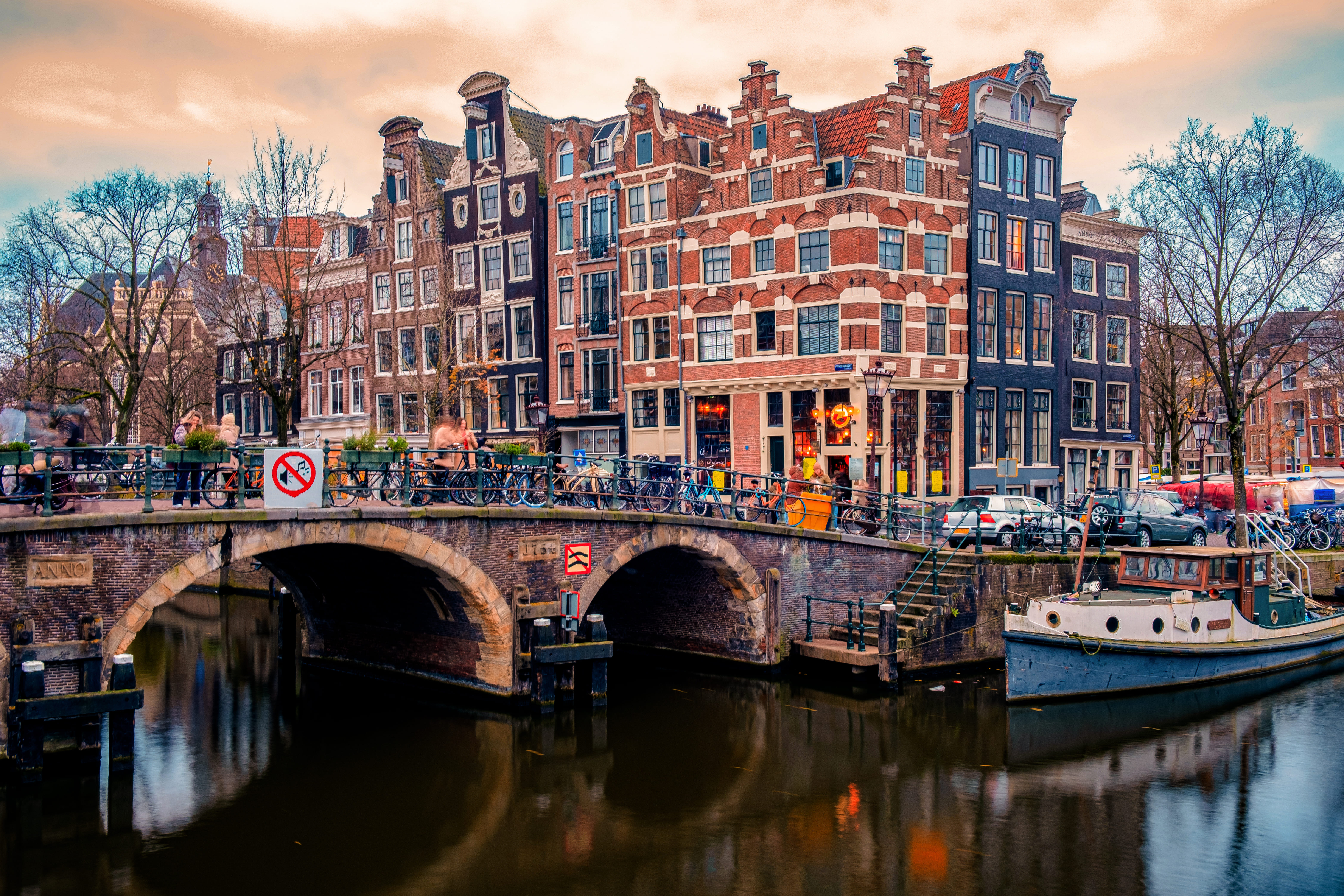 Classic canal bridge and historic waterfront houses in Amsterdam, Netherlands