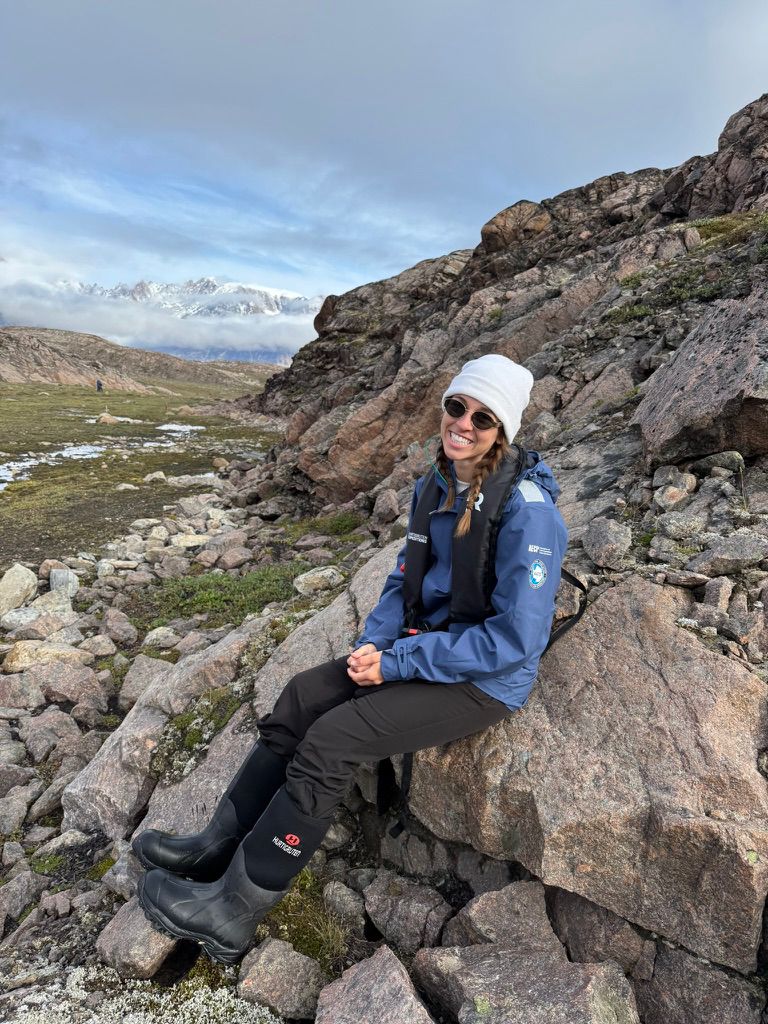 Angela Hughes sitting on rocks