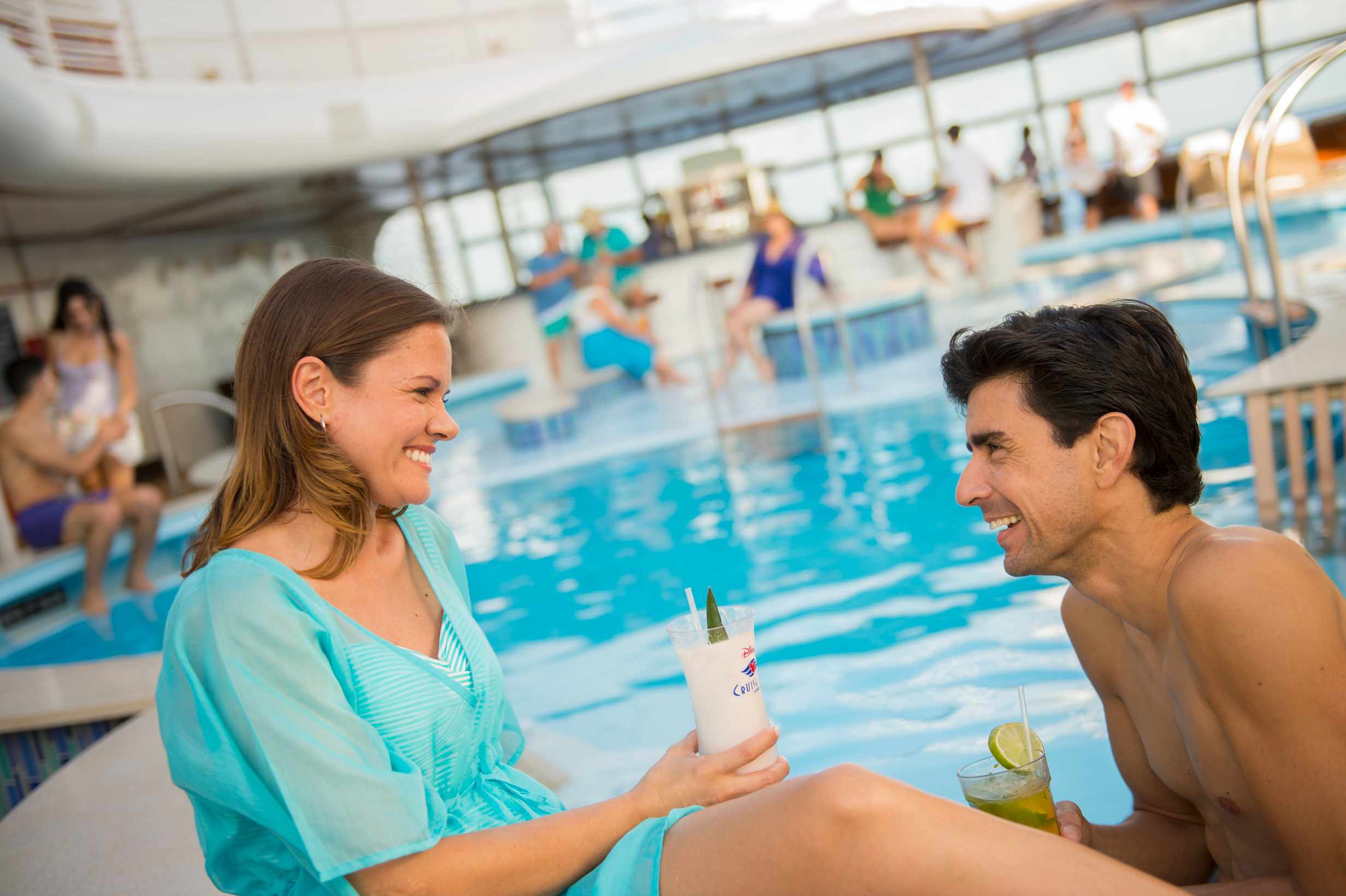 Adults enjoying tropical drinks at a Disney Cruise pool bar