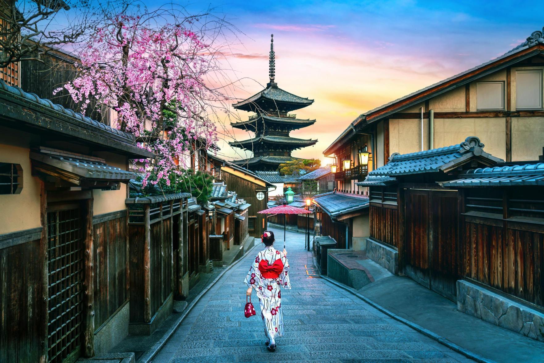 Geisha walking in Gion Kyoto with pagoda view authentic Japan experience curated by Angela Hughes