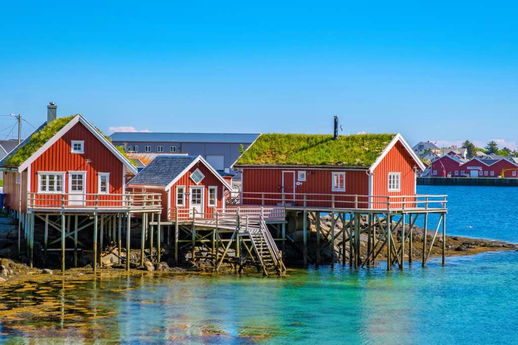 Luxury cruise ship sailing through historic coastal villages