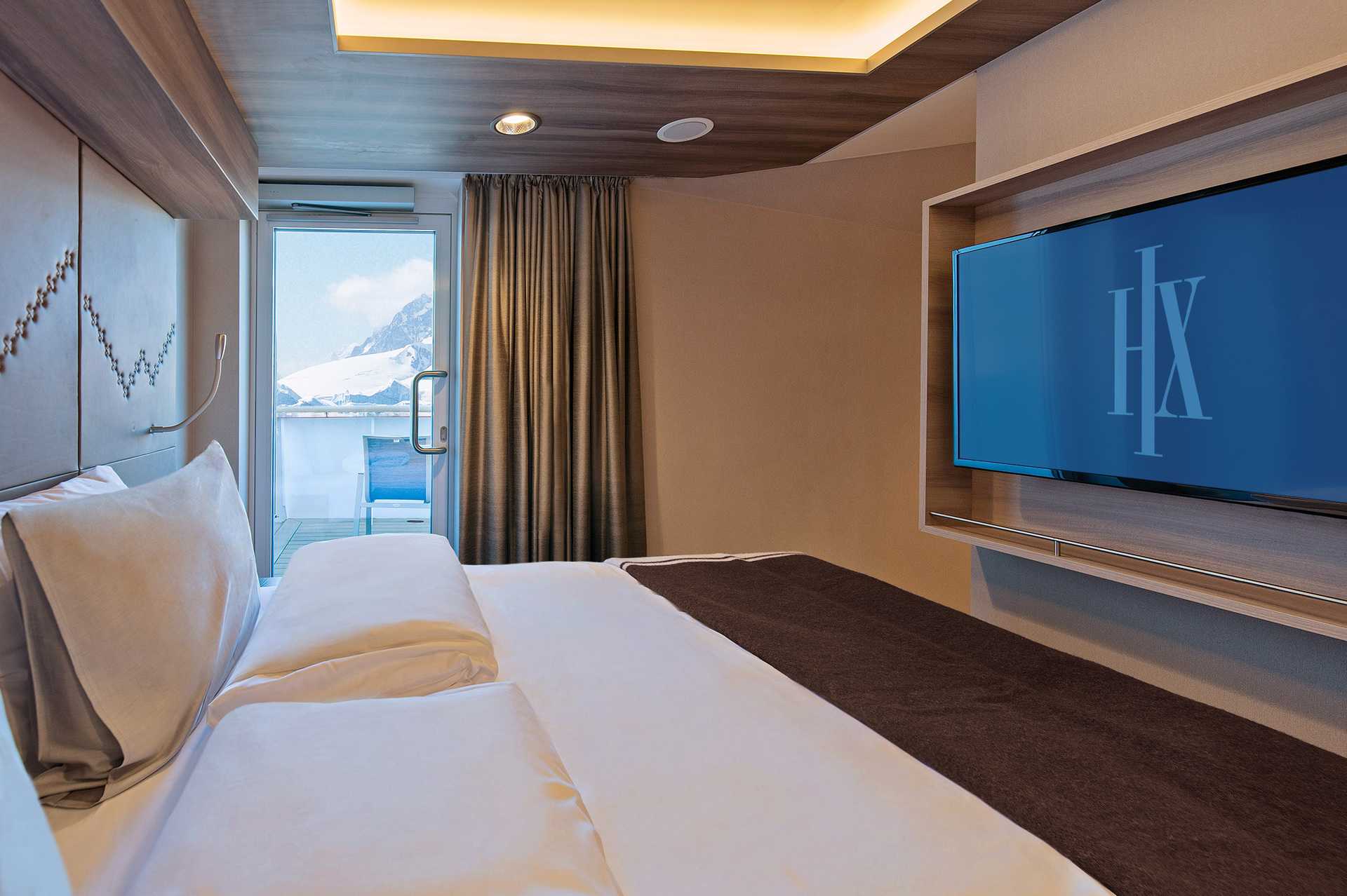 Expedition cruise ship suite with ocean balcony view