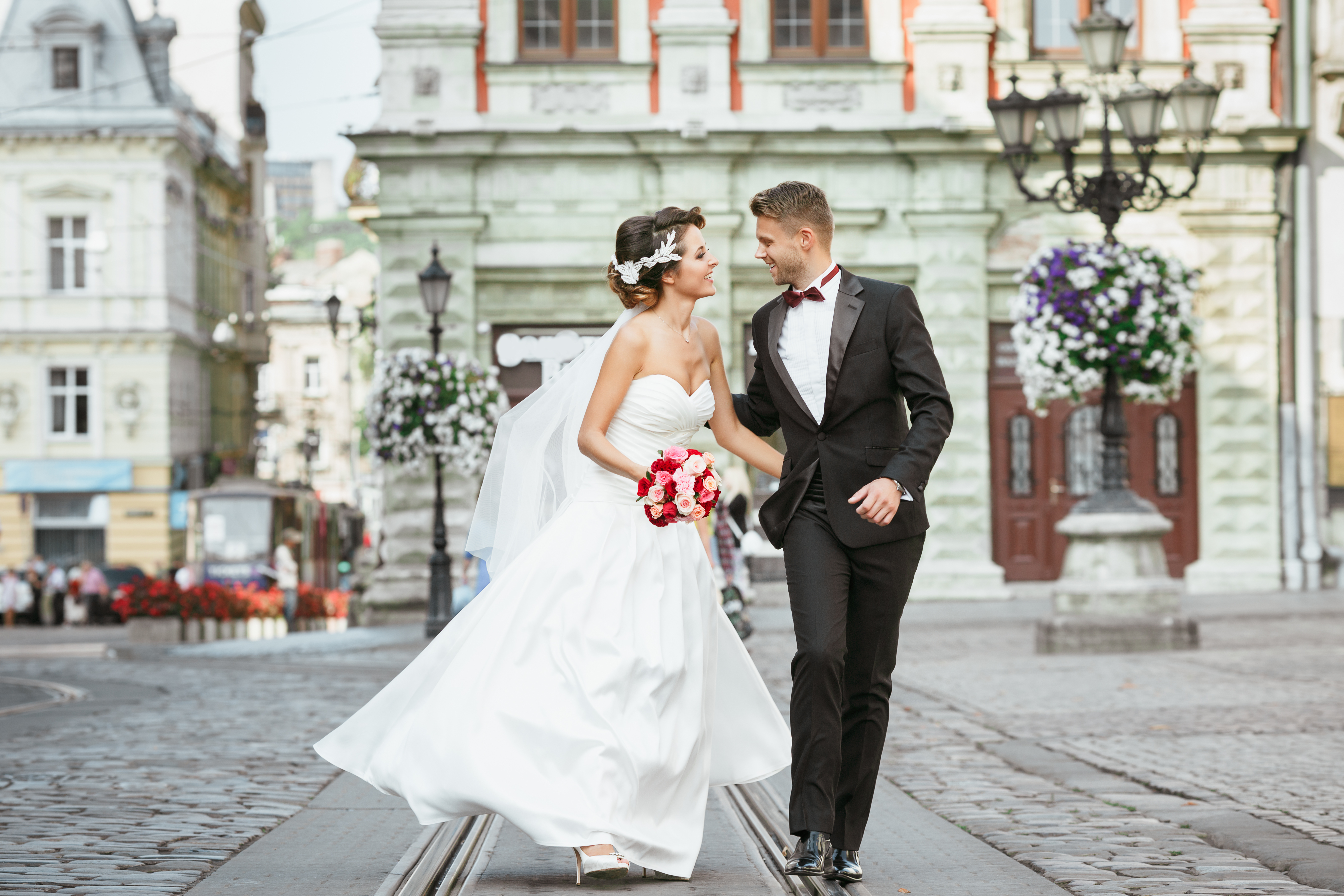 Beautiful bride and groom embracing in romantic city wedding photo