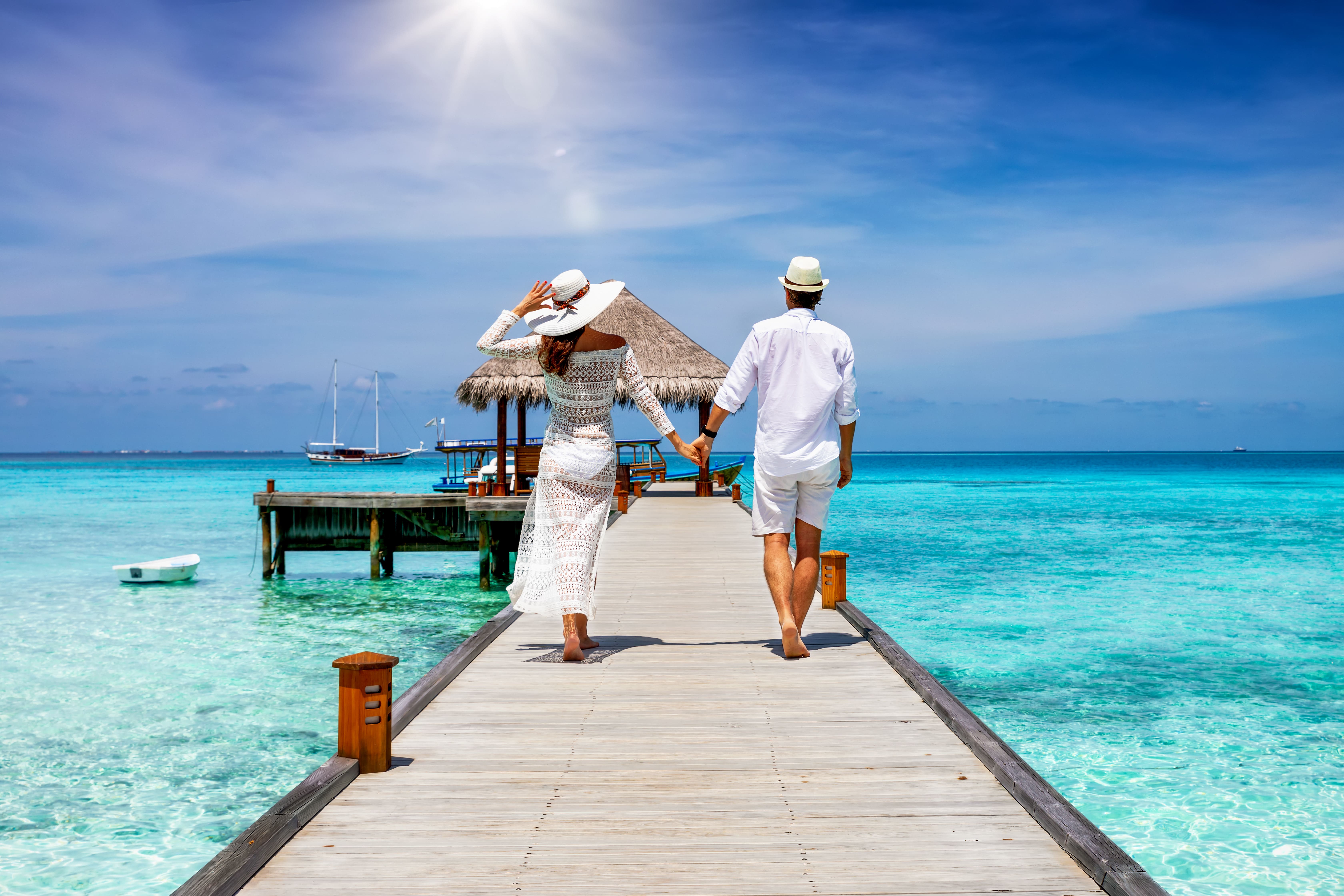 Honeymoon couple at luxury Maldives overwater villa - wedding planning guide