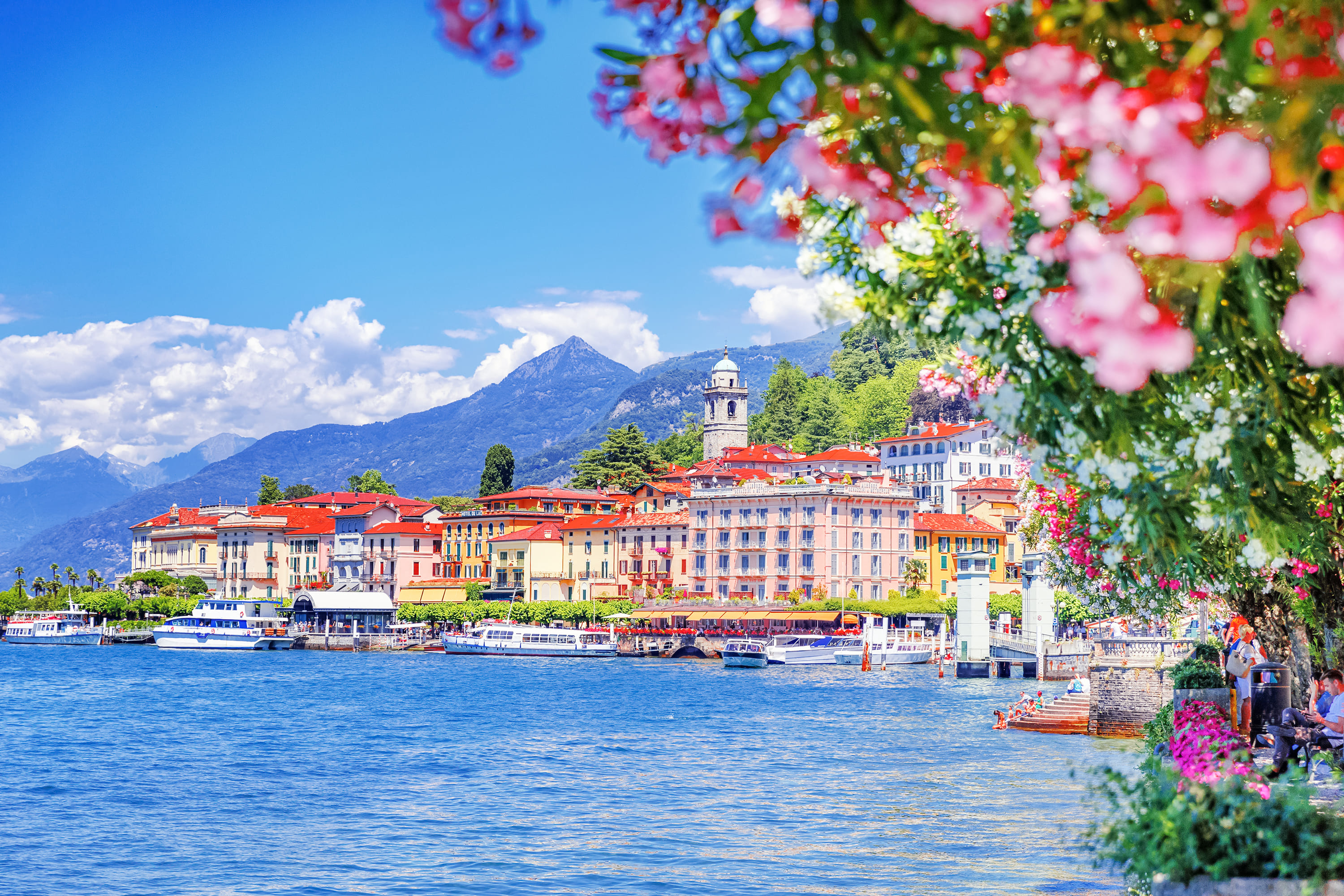 Scenic waterfront view of Lake Como, Italy with luxury villas and mountain backdrop